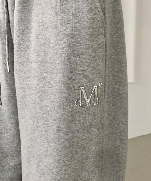 MUCENT(ムセント)/ユニセックス ワイド ルーズ ロゴ ジョガー スウェットパンツ/LASH METAL LOGO JOGGER SWEAT WIDE PANTS UNISEX | AT2252030 | グレー