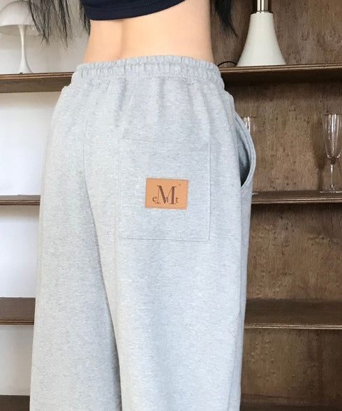 MUCENT(ムセント)/ユニセックス ワイド ルーズ ロゴ ジョガー スウェットパンツ/LASH METAL LOGO JOGGER SWEAT WIDE PANTS UNISEX | AT2252030 | グレー